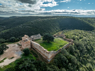 Stone ramparts & crenellated walls define Paderne Castle's medieval architecture, a historic...