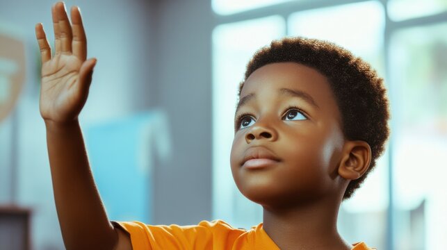 Smart Black boy raising his hand in a bright and modern