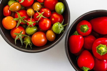 freshly picked cherry tomatoes and small red bell peppers, simple healthy ingredients from the...