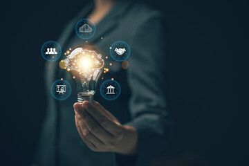 Businessman holding a light bulb that shines. Idea search concept. Education. Using AI to help create new ideas....
