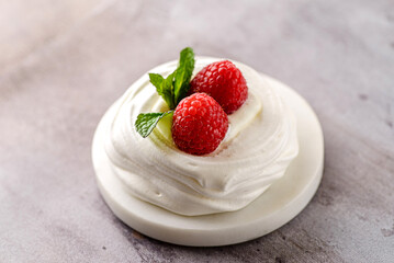 pavlova meringue dessert with raspberries and cream