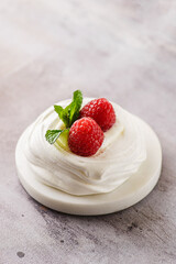pavlova meringue dessert with raspberries and cream
