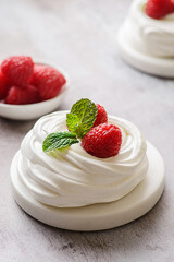 pavlova meringue dessert with raspberries and cream