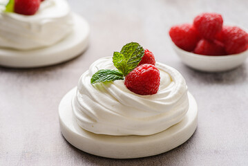 pavlova meringue dessert with raspberries and cream
