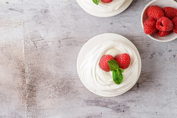 pavlova meringue dessert with raspberries and cream