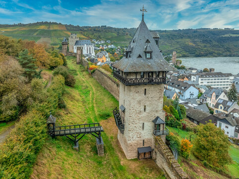 Aerial view of Oberwesel medieval city walls restored Gothic gate tower, drawbridge and church along the Rhine river in Germany - Powered by Adobe