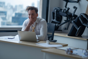 Depressed entrepreneur in formal suit, worker man sitting in office. Upset male businessman lost...