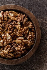 organic raw walnuts in a wooden bowl