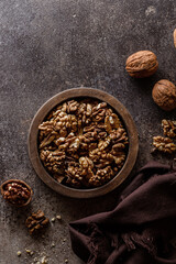 organic raw walnuts in a wooden bowl