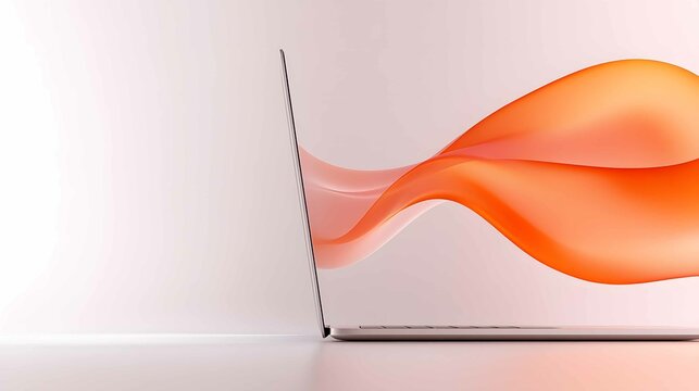 Modern laptop on a minimalist desk with a dynamic orange wave design flowing from it