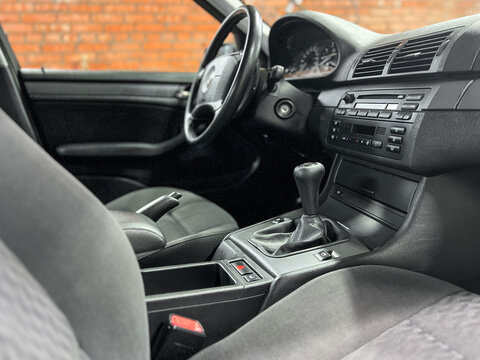 BMW 3 series E46, car interior, steering wheel, gear shifting, dashboard. Black velour interior of BMW E 46.