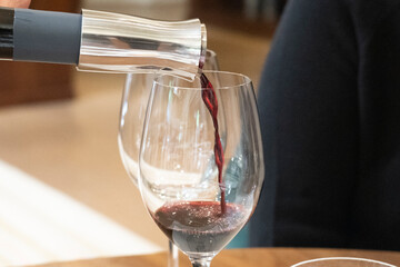 pouring red wine into glass