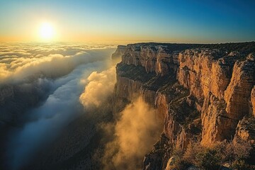 Canyon edge view with dense fog rolling in under bright sunset