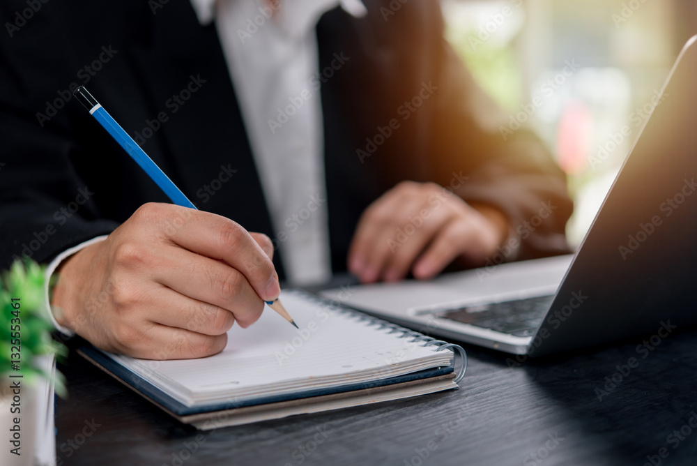 Poster man hands with pen writing on notebook in the office.learning, education and work.writes goals, plan