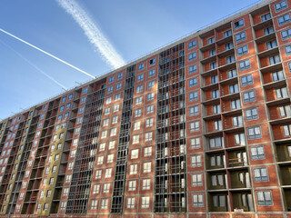 A fragment of the facade of a multi-storey residential building under construction. Construction of...