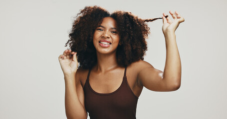 Happy, afro or black woman for hair care, texture and glow for portrait, volume and natural shampoo. Studio, pull or model with beauty, smile and growth for cosmetics and results by white background © C.D./peopleimages.com