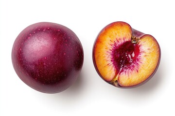 Obraz premium Two plums, one whole and one halved, displayed against a white background.