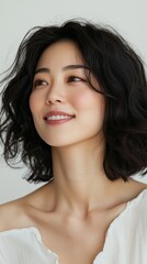 Naklejka premium A woman with short hair and a white shirt is smiling