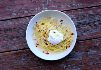 Creamy spaghetti carbonara served in a white bowl