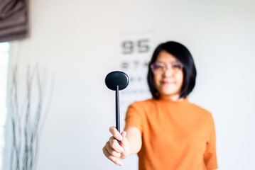 Asian woman checking up vision closing eyes test at hospital