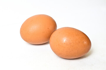 Two fresh raw chicken eggs isolated on white background. Close up view.