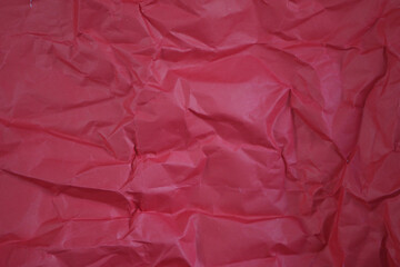 Crinkled Crimson: Abstract close-up of a textured, folded crimson paper. The intricate pattern and subtle gradations of light create a visually compelling design.