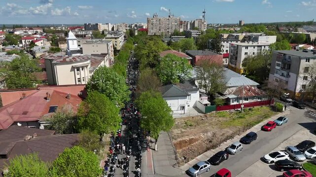 Aerial footage of people gathering for a wedding ceremony in front of Annunciation Church, Romania