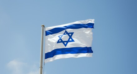 A blue and white flag blowing in the wind against a bright sky