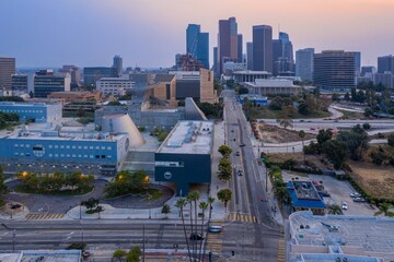 Fototapeta na wymiar Los Angeles, USA: An elevated view of Grand Avenue, with cars moving along the street. The Dorothy Chandler Pavilion and other buildings are visible. The photo shows the city at dusk.