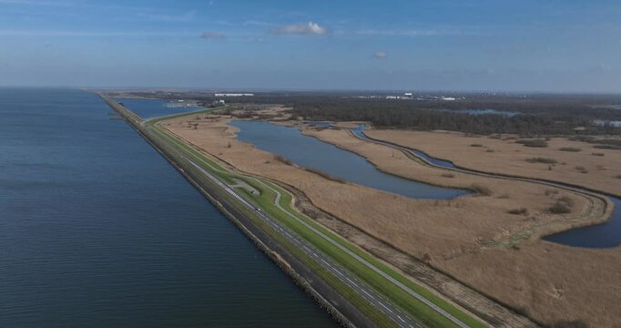 Oostvaardersplassen large marsh area with reed plains, rough grasslands, ponds, surrounded by forests. Nature park, The Netherlands. Aerial views.