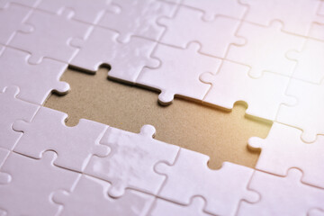 Fototapeta premium White jigsaw puzzle with missing pieces, Importance of people in business organization, Collaboration and teamwork concept.
