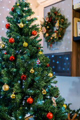 Decorated Christmas tree with colorful balls, toys and sparkling garlands