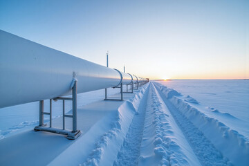 Newly build oil and gas pipeline constructed over snow covered fields in Alaska during winter, transporting liquefied natural gas (LNG) and crude oil to ports and refinery for processing and export.
