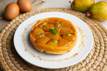 Pear tart tatin made with a traditional French recipe in a Paris restaurant.