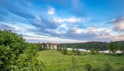 A beautiful, serene landscape with a lake and a forest in the background