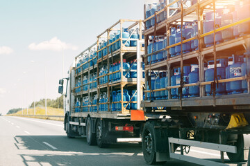 Naklejka premium Truck carrying propane tanks on highway
