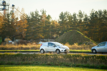 Modern white car on rural roadside