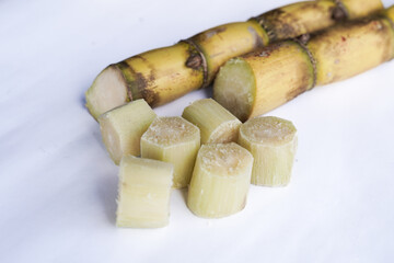 A bunch of sugar cane is cut into small pieces
