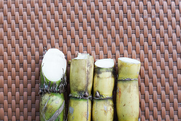 A bunch of sugar cane is cut into small pieces