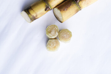A bunch of sugar cane is cut into small pieces