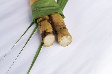 A bunch of sugar cane is cut into small pieces