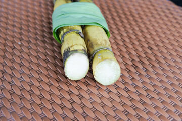 A bunch of sugar cane is cut into small pieces