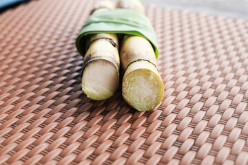 A bunch of sugar cane is cut into small pieces