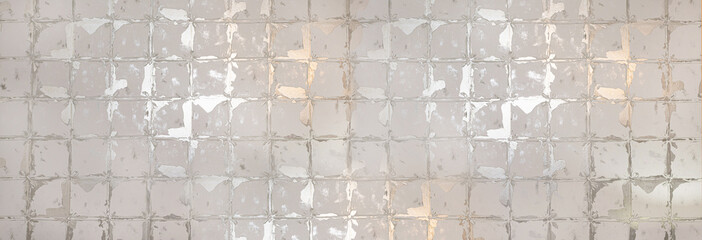Old damaged ceramic tiles showing deterioration and wear creating an abstract pattern