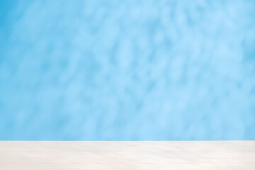 Template with empty table and wall with natural shadow and sunny glare
