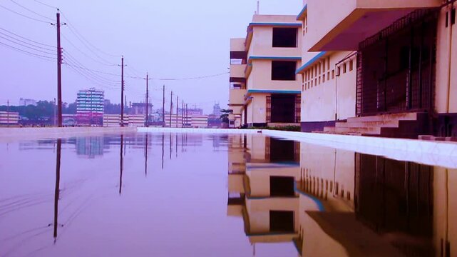 A large pool with a view of the building side. Rifleciton view. Bangladesh Biswa Ijtema Field outdoor view with big swimming pool and washroom.