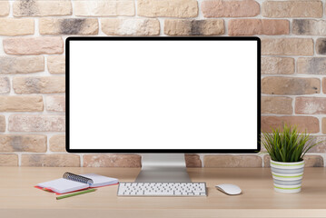 Fototapeta premium A cozy workplace setup featuring a PC with a blank screen monitor on a desk