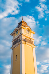 Burgas railway station features bright yellow architecture under a clear sky, welcoming travelers with charm. vertical