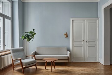 Fototapeta premium Light blue room with sofa, chair, and wooden floor.