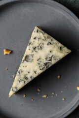 cheese with blue mold on a grey plate
